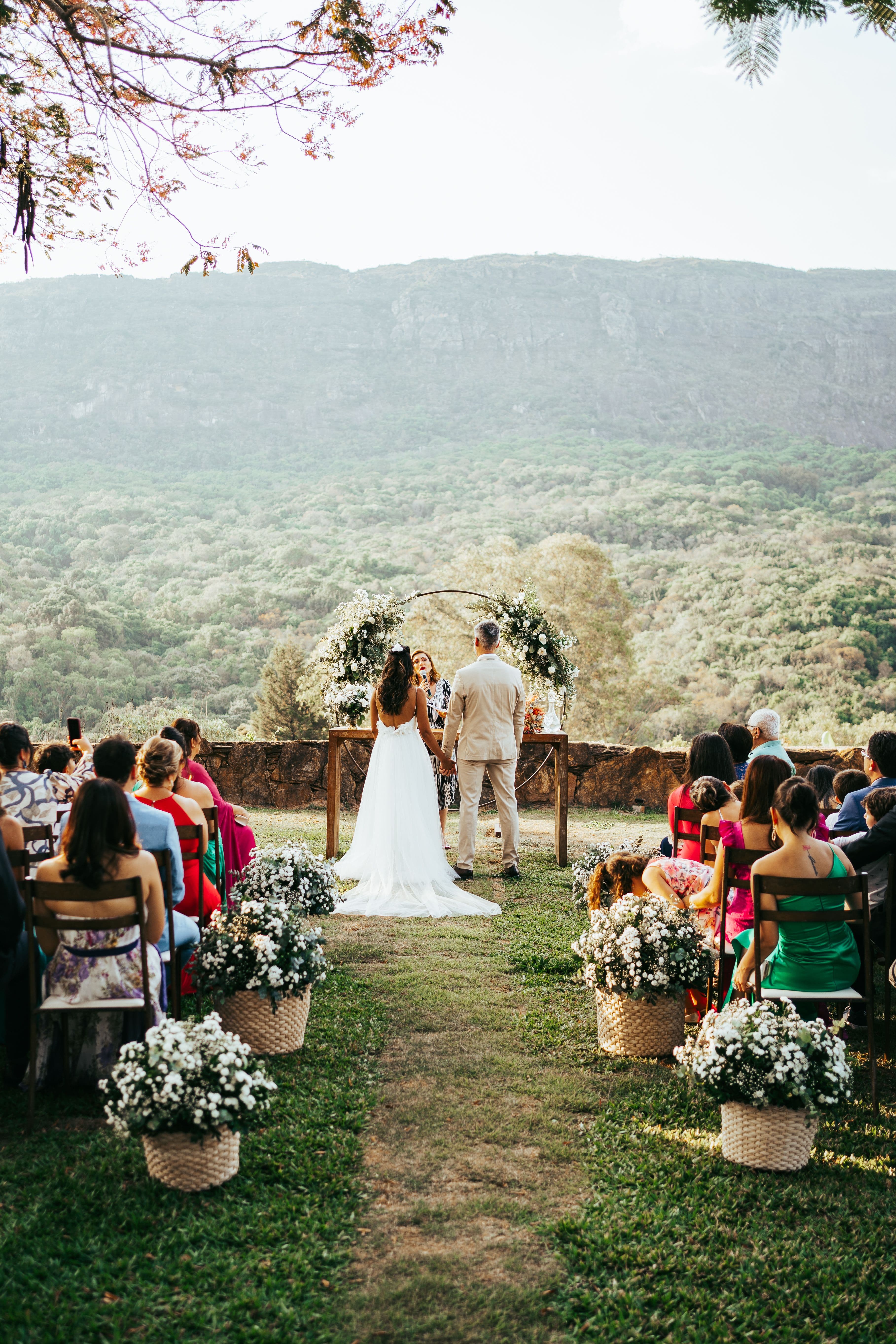 Outdoor wedding ceremony overlooking a green landscape
