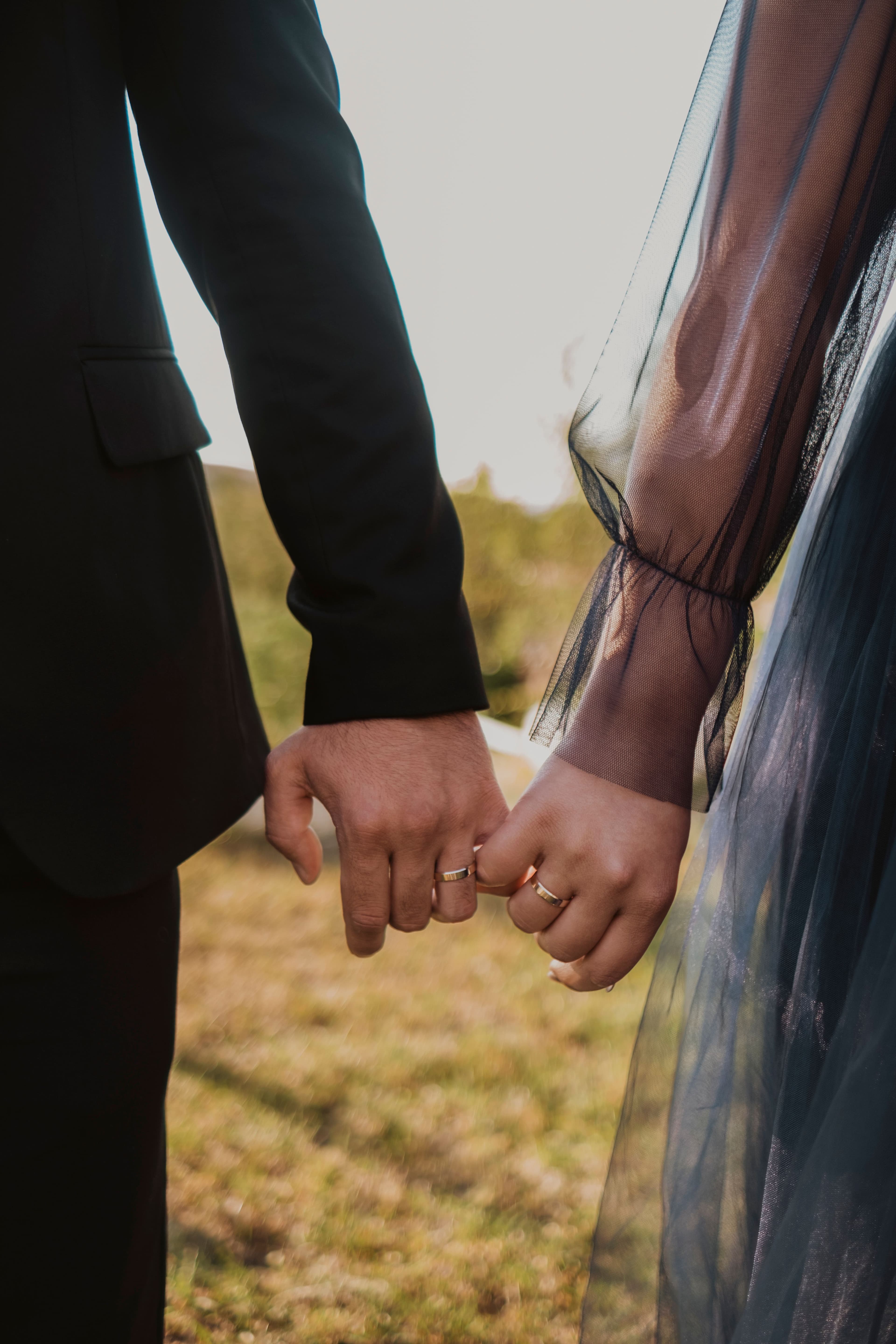 Newlywed couple holding hands