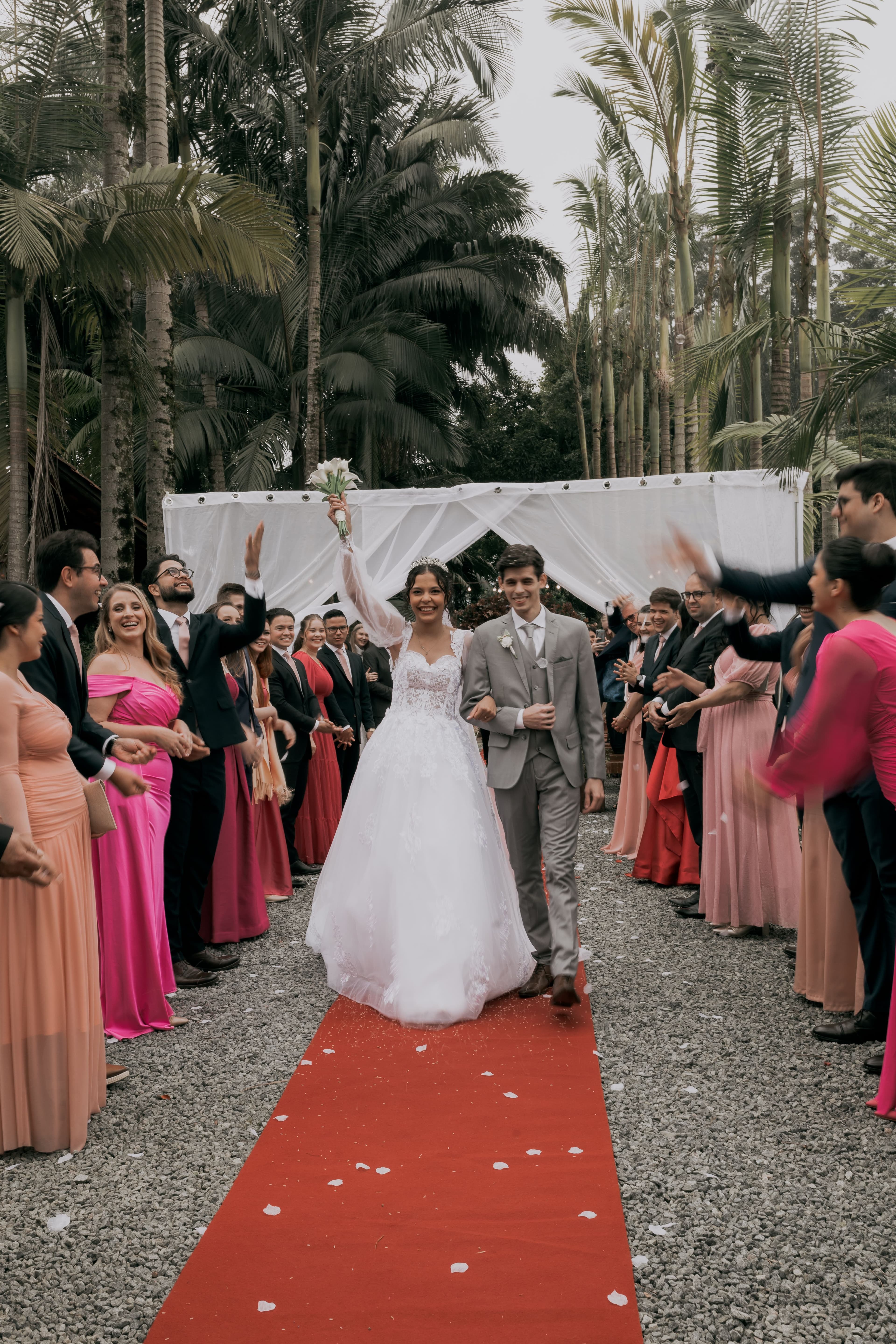 A newly married couple walking through their celebration